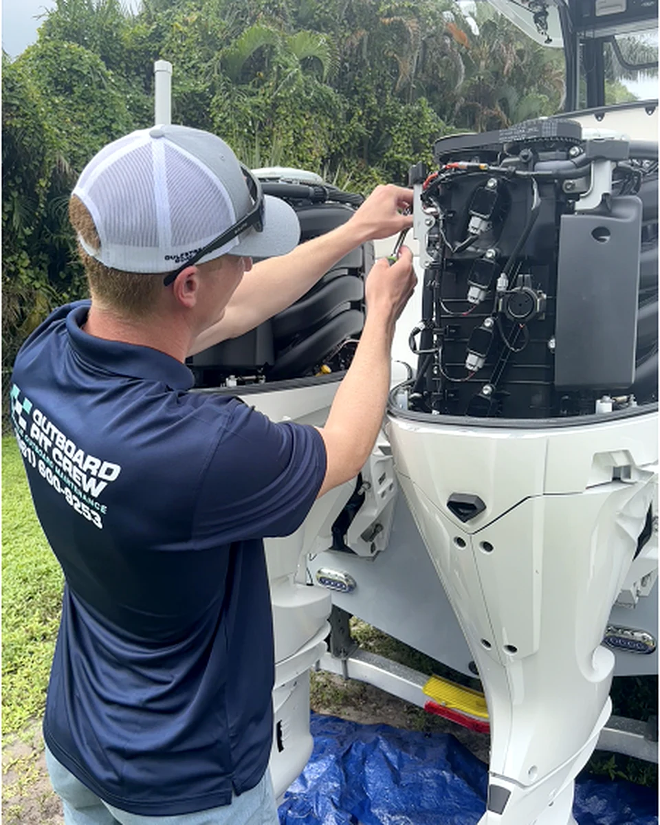 Outboard Pit Crew technician servicing twin Yamaha outboards in Palm Beach County